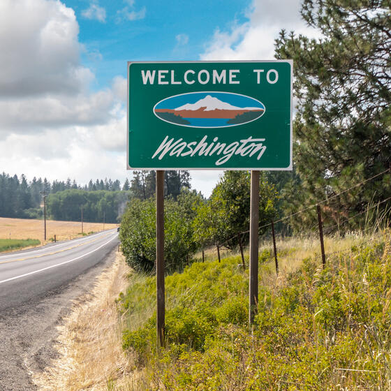A "Welcome to Washington" sign along a highway