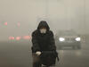 A cyclist in Beijing on a day of heavy pollution in December 2015.
