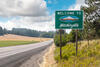 A "Welcome to Washington" sign along a highway